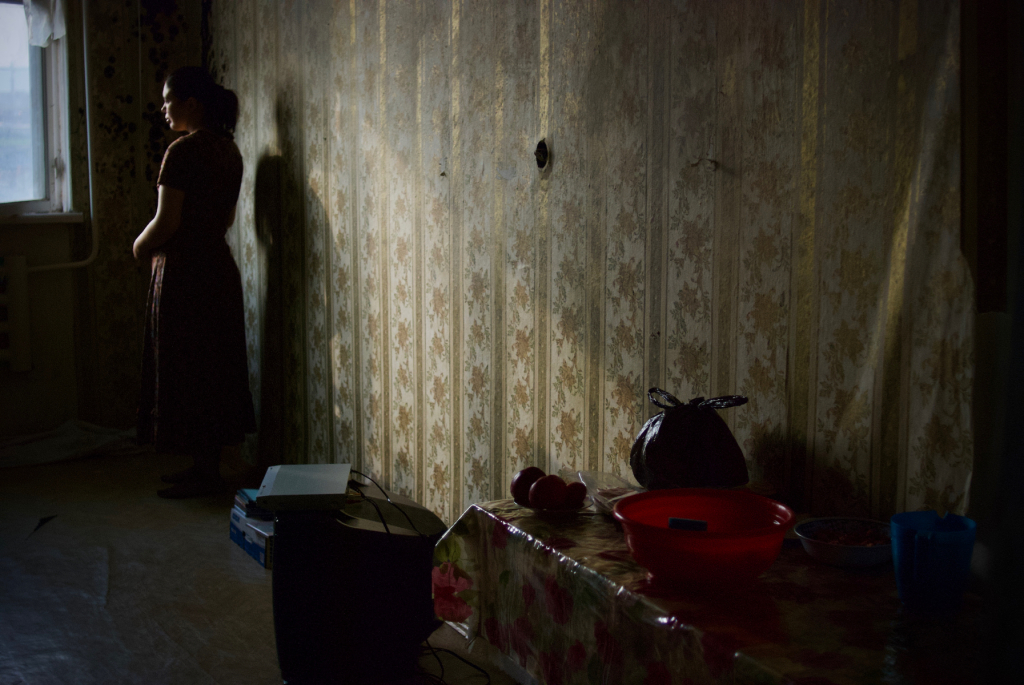 Maria Morina. A teenage girl in her room in a dormitory for refugees, 2009. Grozny, Chechnya